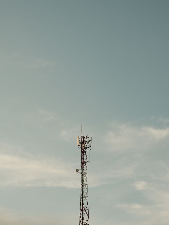Mastering the First Impression: Your intriguing post title goes here A solitary cell tower stands tall against a clear sky, symbolizing modern connectivity.